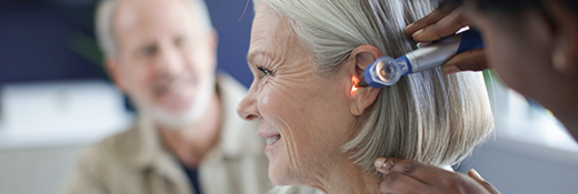 Image of a woman getting a hearing exam